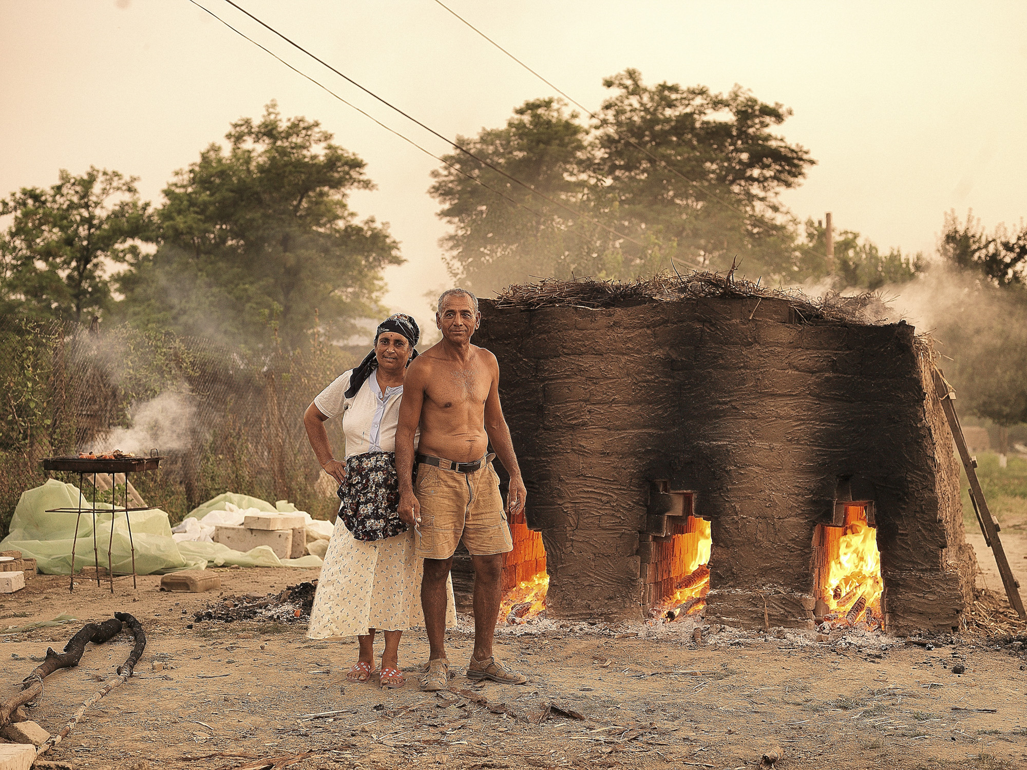 An old couple making bricks and burning them for 24 hours. This is their only way to earn money.  
