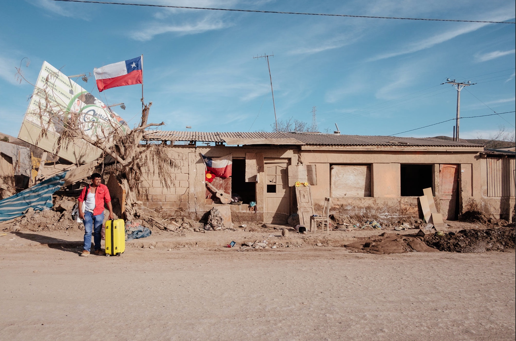 A bus to better lands - resident waiting for transport out of there, a Chilean flag waving symbolically in the air. 