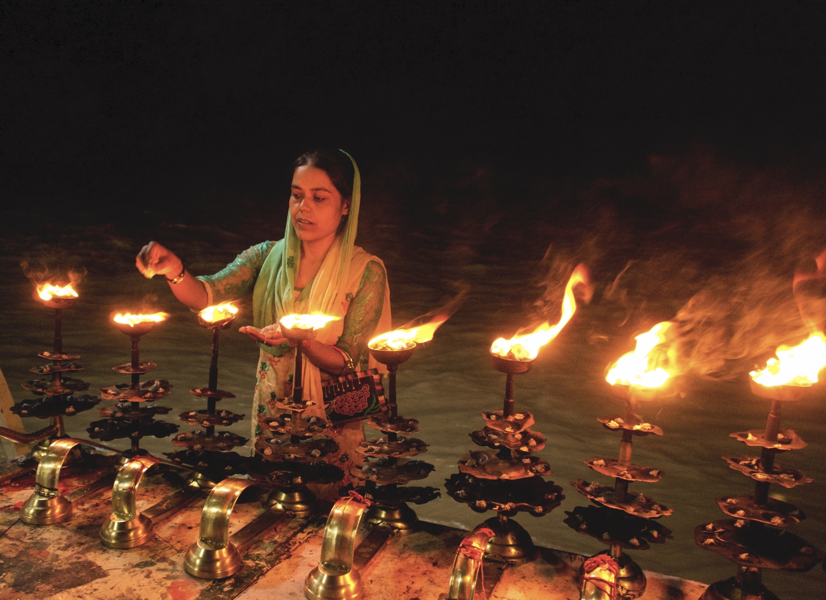 A devotee asking to fulfill her wishes from mother Ganges after the ceremony. Ganga river is believed to remove sins