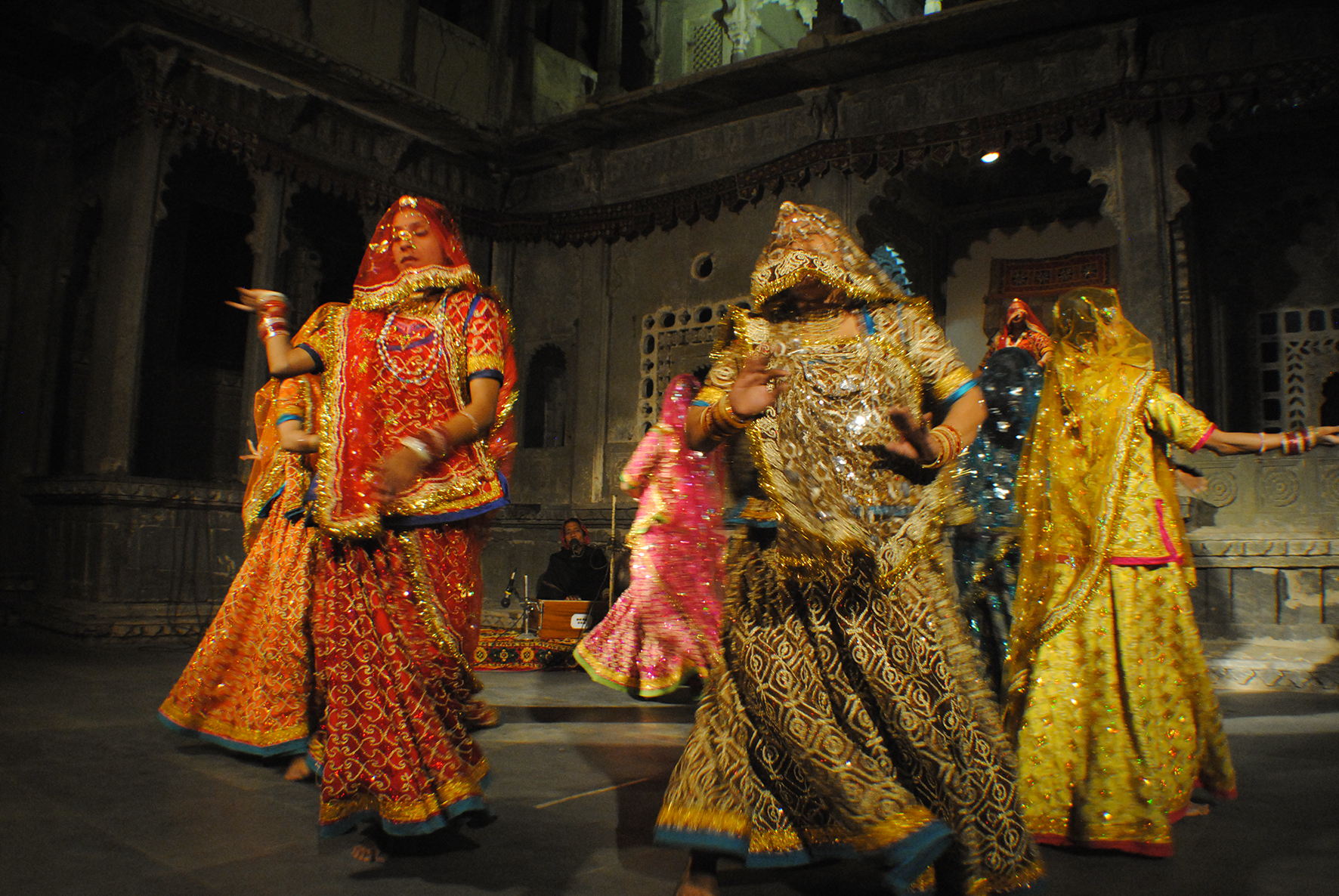 Rajasthani folk dancers move in and out a wide circle while moving gracefully to the rhythms of the traditional Ghoomar dance. Their outfit consists of an opaque or translucent veil and the Ghaghara dress.