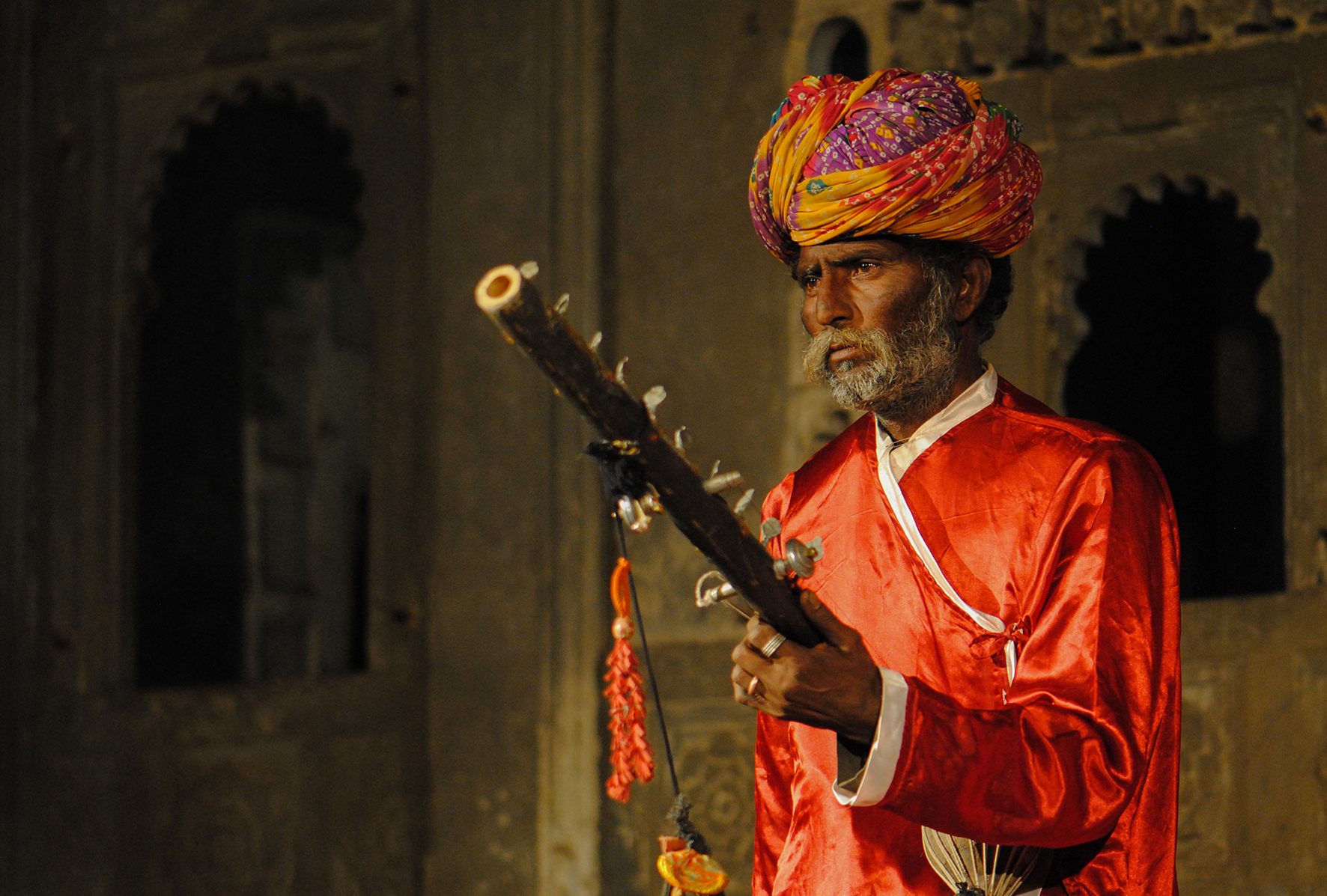 Dancers are accompanied by an elder sarangi player—a traditional instrument.