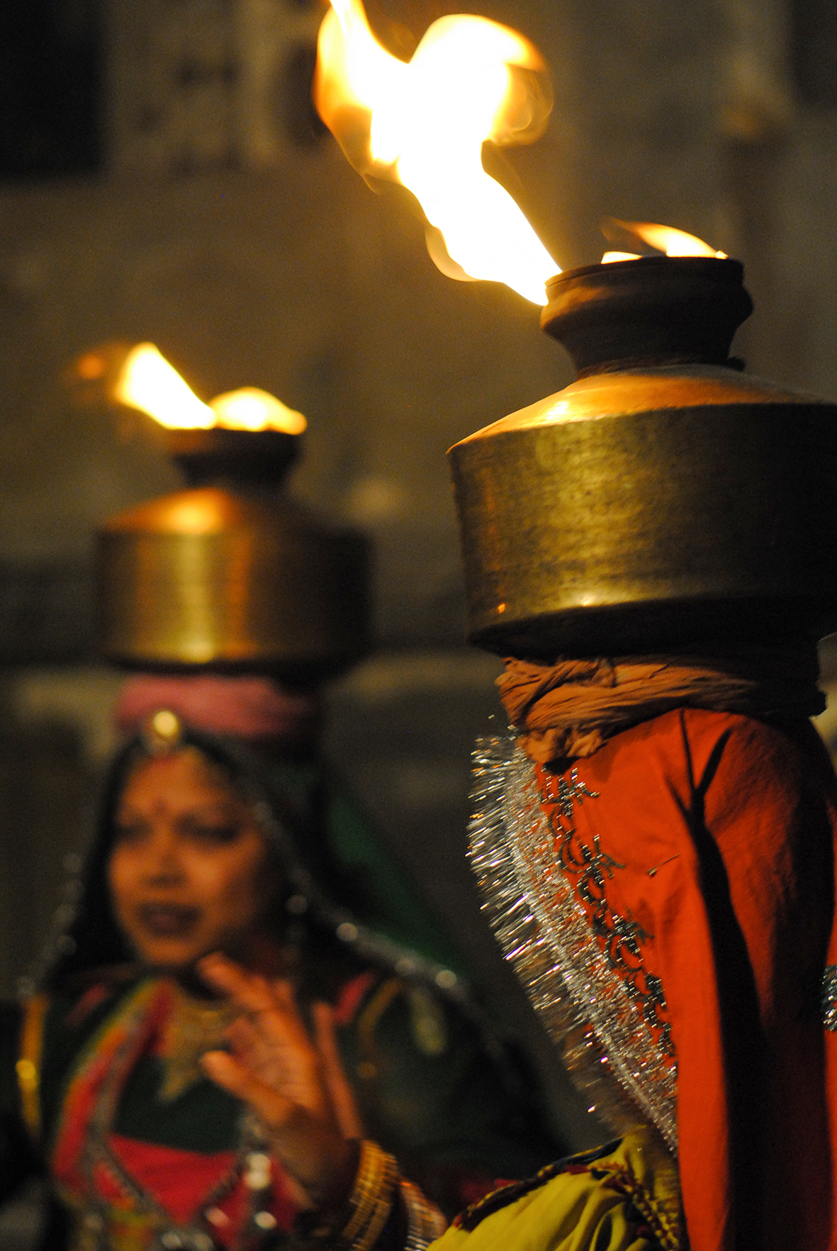 The women dance while balancing brass chari on their heads. The chari ritualistic dance is usually performed on special occasions, such as marriages or festivals.