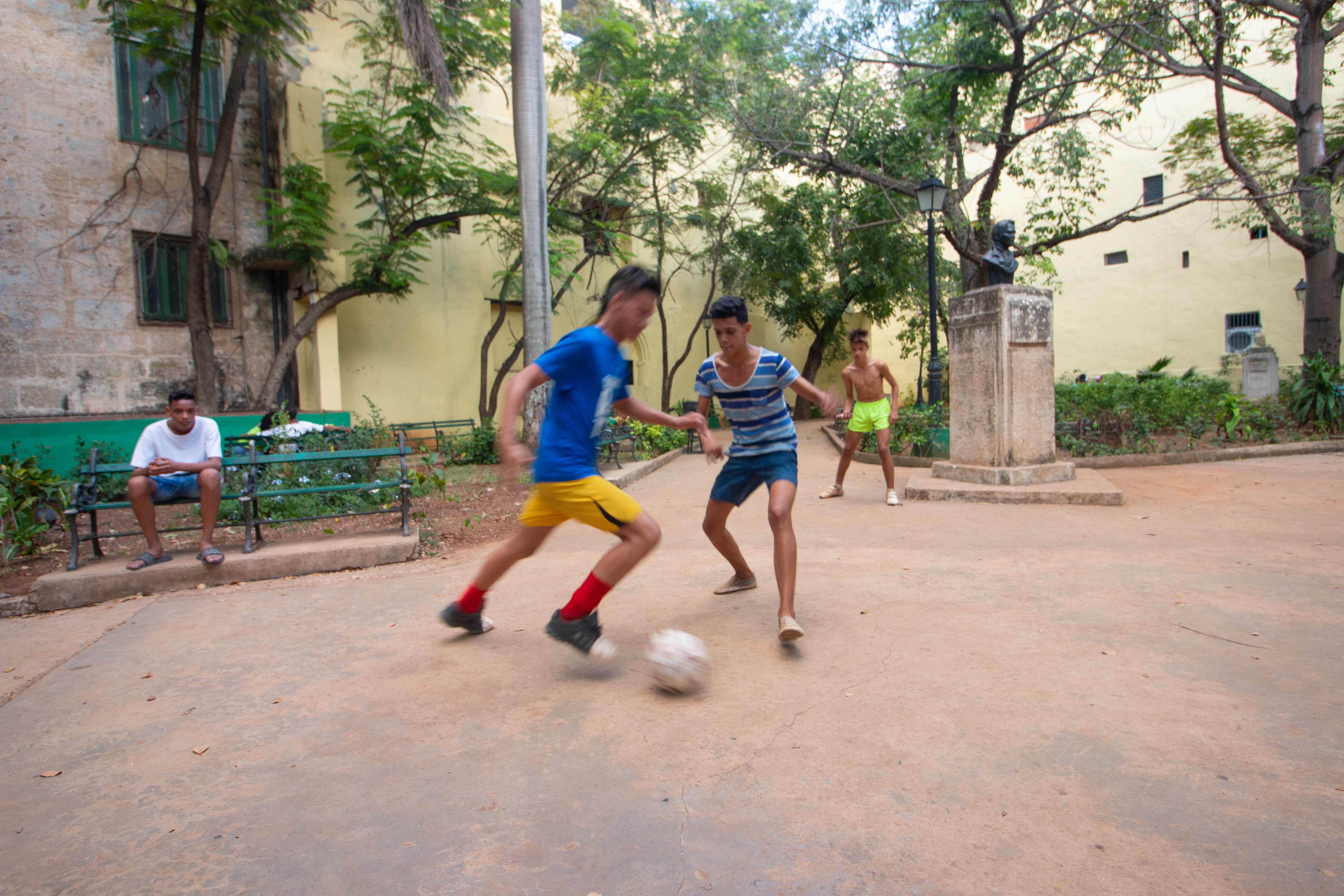 Soccer and baseball are the two most popular sports, kids would flock to any open ground they can find after school. Here, they have improvised two goals with the bushes lining the paths of the public garden. The matches are intense yet filled with goofiness alongside Messi jerseys.