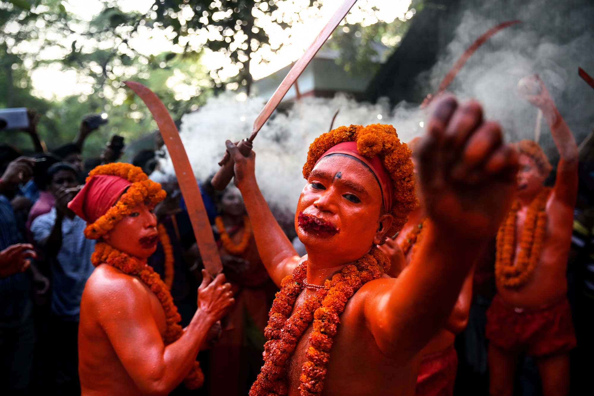 Hindu devotees dance on the street as they celebrate Lal Kach festival during the last day of the bengali month in Narayanganj, Bangladesh.