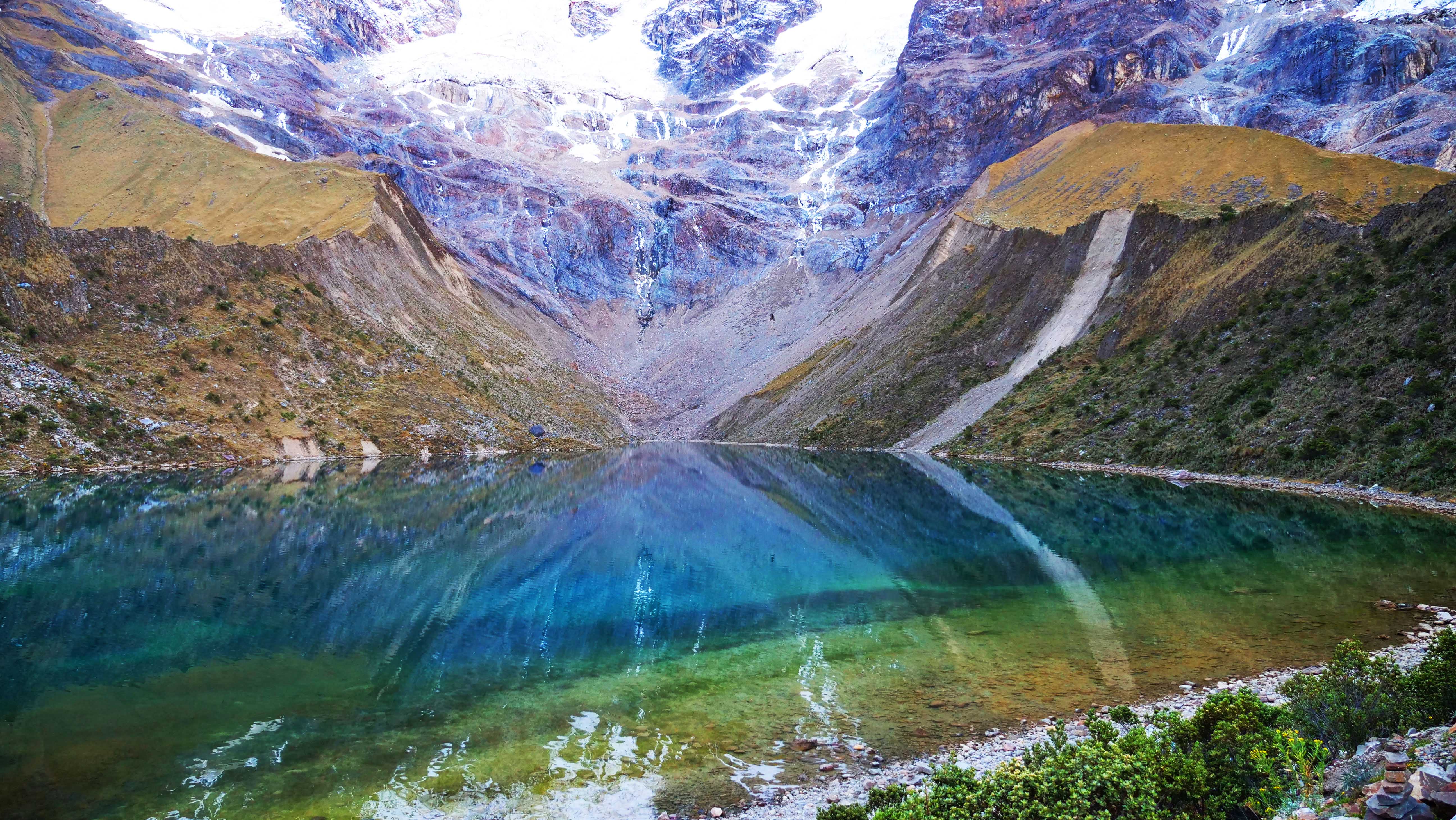 At sunset the lake's glassy surface reflects the colorful face of the glacier that feeds it.