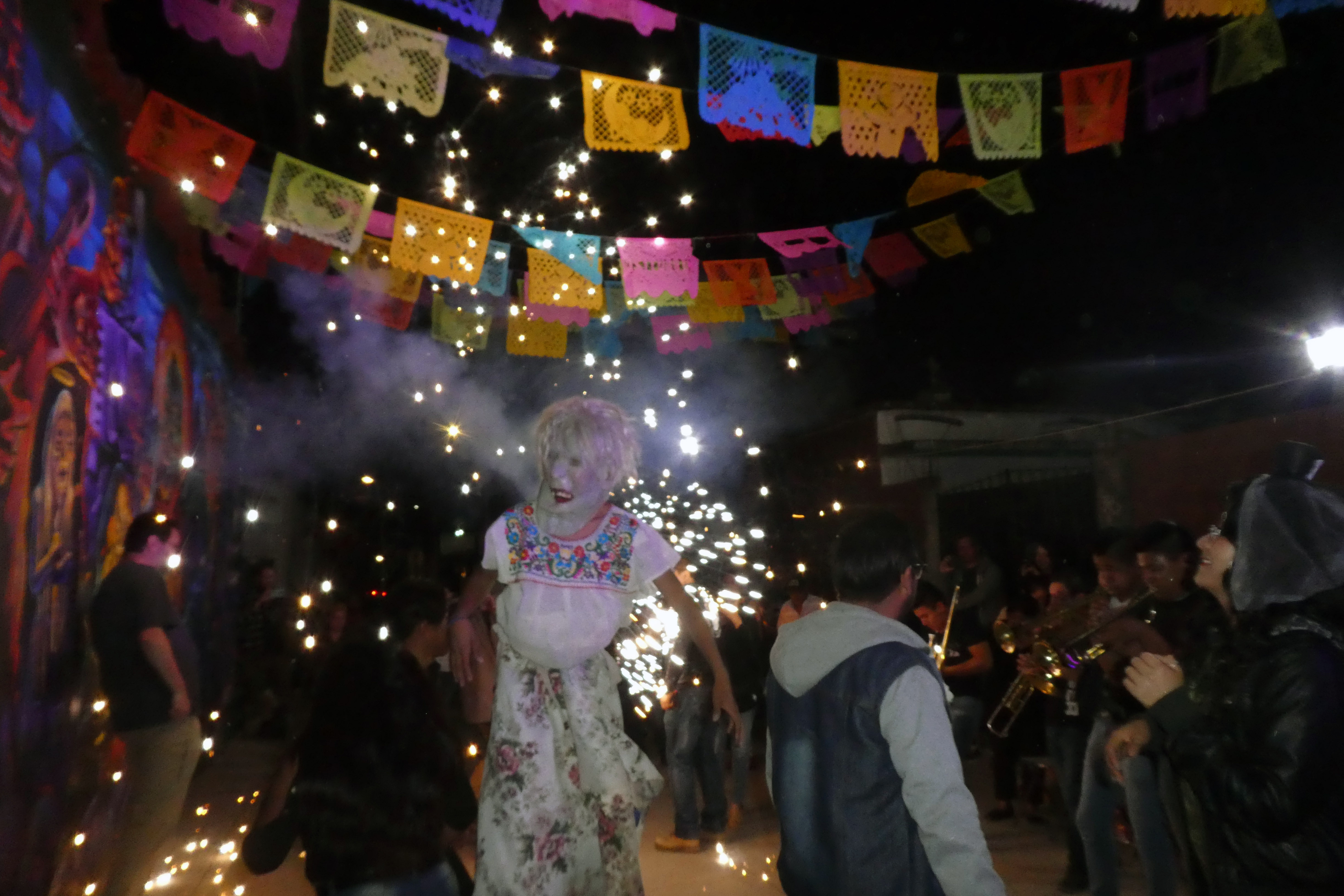 With satisfied souls, peaceful hearts,&full bellies the secular nighttime parades began. Papier-mâché masked dancers flew to the beat of the brass mariachi bands as fireworks lit their colorful paths. The mural lined streets were painted with memento mori & cozily enclosed with delicate papel picado