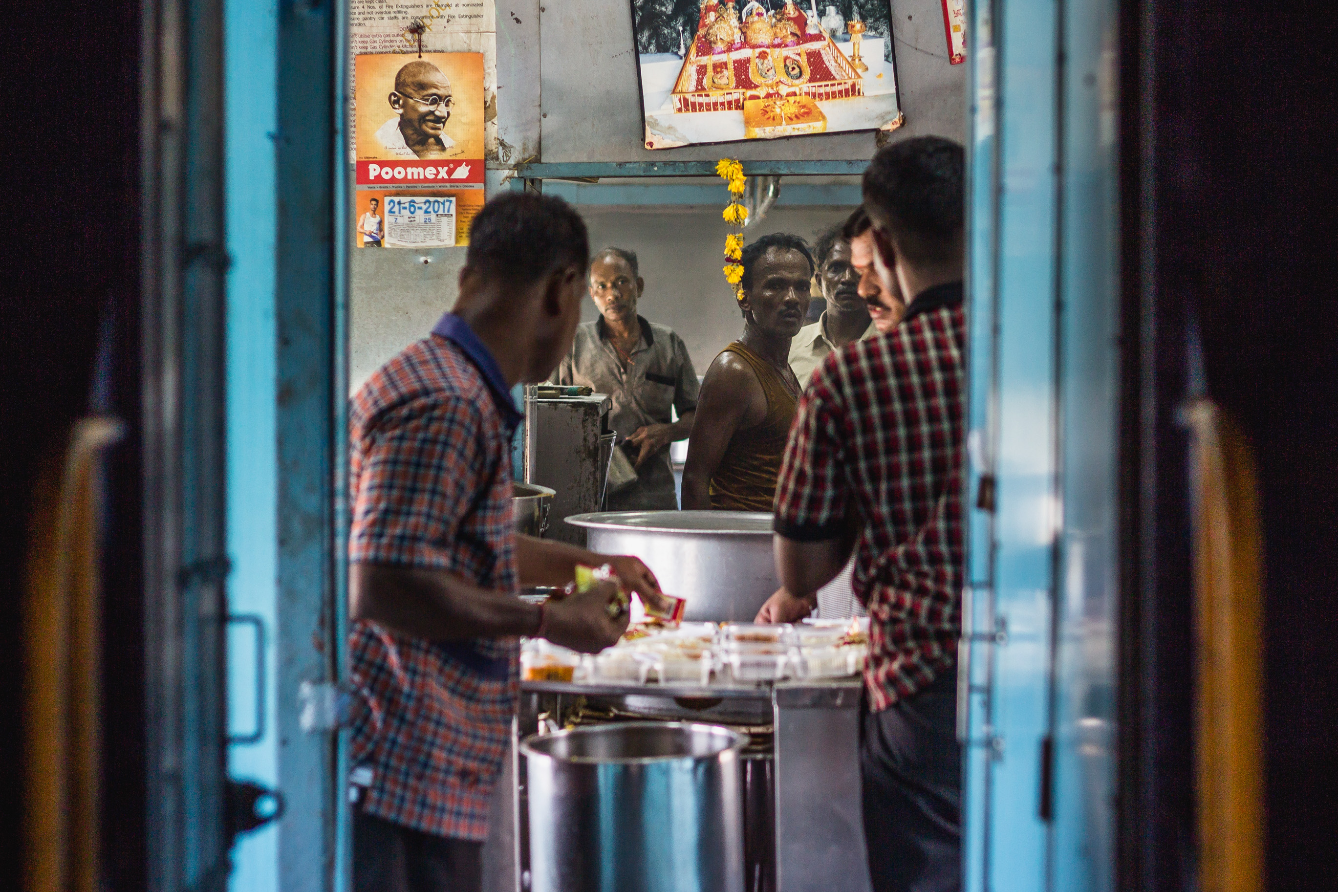 Usually, train rides take long hours up to a couple of days. In one of the carts, local chefs prepare the most delicious thali and samosas for all of the people on the train. They cook nonstop under the intent gaze of Gandhi. 
