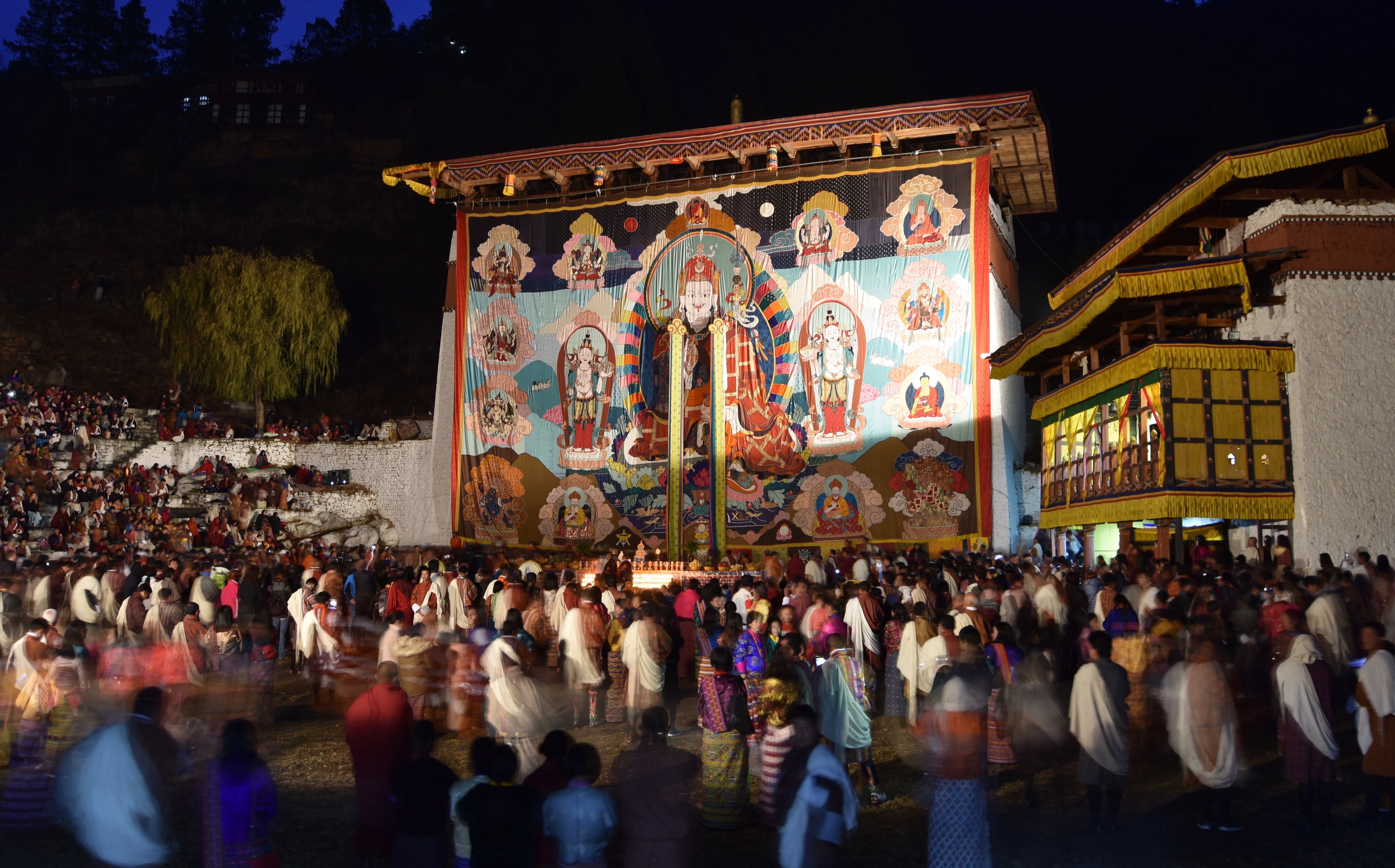 Long before dawn on the last day of the Paro Tsechu, devotees flock to the unfurling of a precious appliqué banner (called a Thongdrol) depicting Padmasambhava, one of Bhutan's most revered Buddhist saints.  To witness the Thongdrol is to receive a great blessing. 
