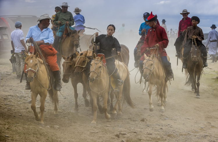 Spectators on horseback at a regional Naadam festival in Mongolia.