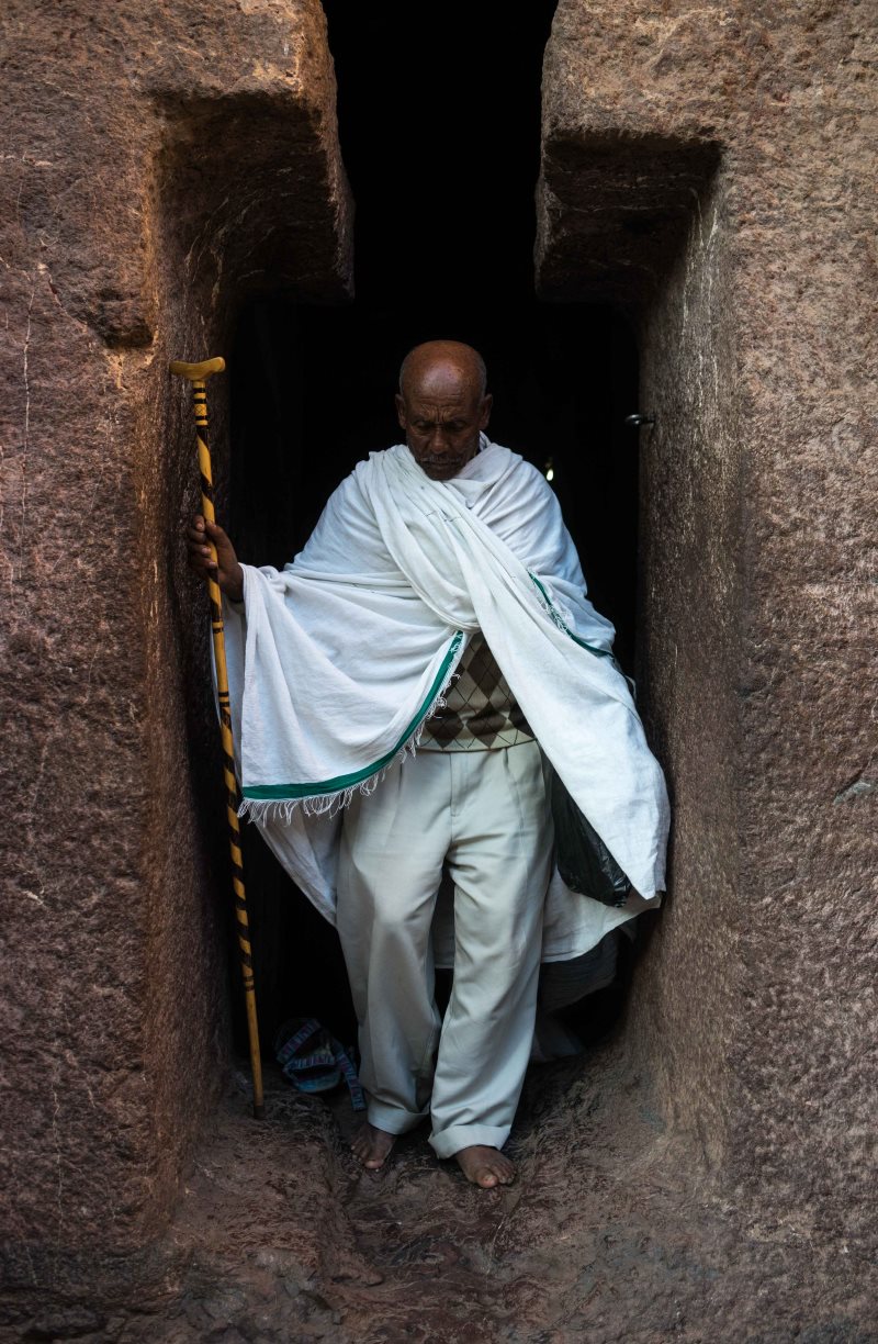 A pilgrim navigates Lalibela's narrow complex of hand-carved churches.