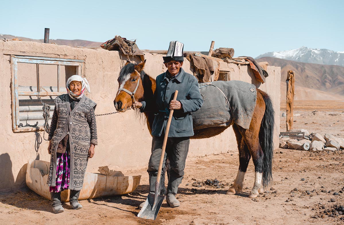 An older couple living on the edge of Bulunkul. The man sports a traditional Kyrgyz hat.