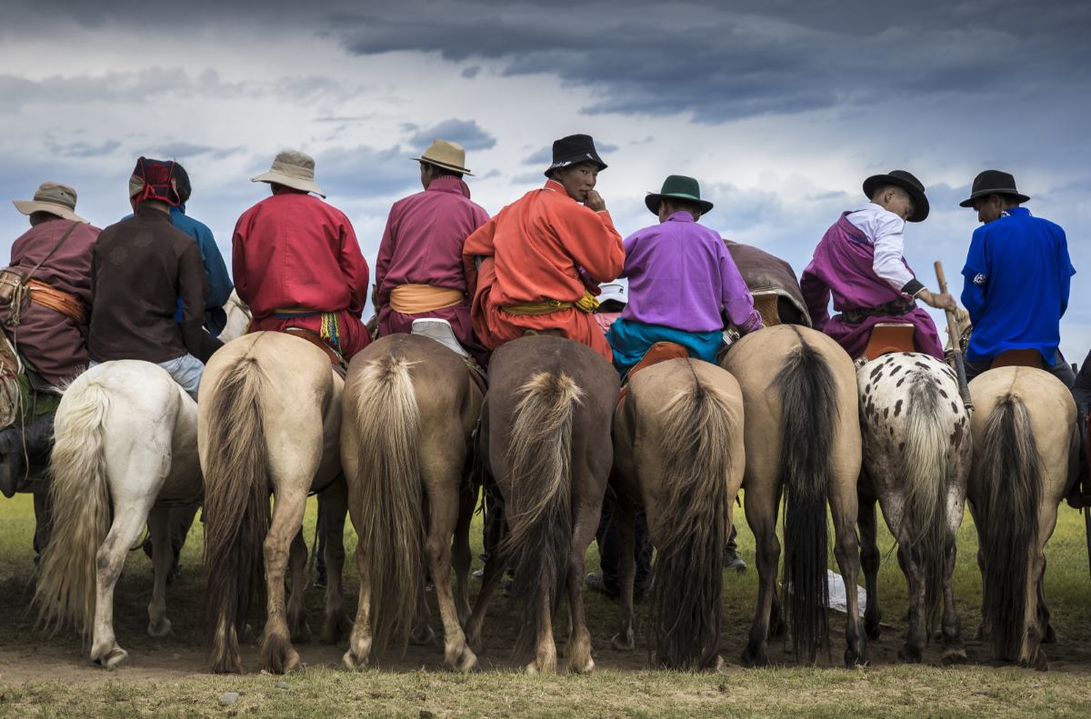 The major event of the festival is the horse races. These are spectators lined up at the finish line waiting for the horse race to finish.