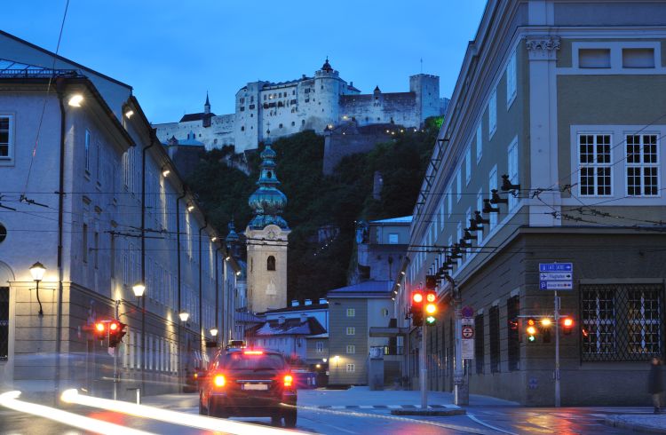 Evening traffic in Salzburg with view of Hohensalzburg Fortress in background