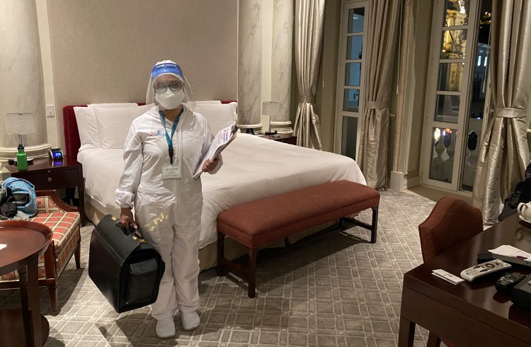 A nurse arrives in a hotel room in Ecuador to do a private COVID-19 test .
