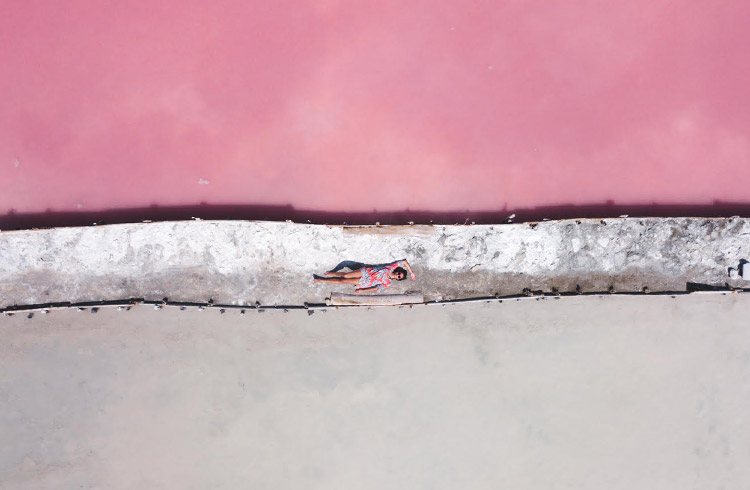 Laying down between a pale pink and darker pink salt mine