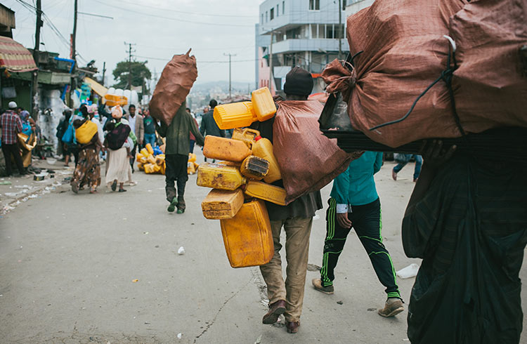 Men carrying recycled goods at "Mercato Market" in Addis Ababa, Ethiopia
