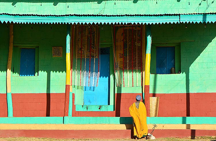 A priest in front of a colorful Church in Axum northern Ethiopia Located in the Mehakelegnaw Zone of the Tigray Region near the base of the Adwa mountains
