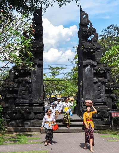 People walking through a shrine in Indonesia