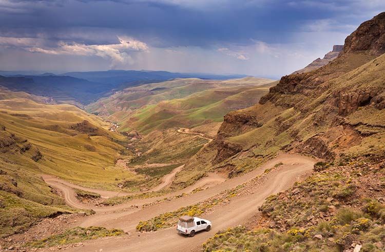 A car driving the hairpin turns of the Sani Pass on the border of South Africa and Lesotho