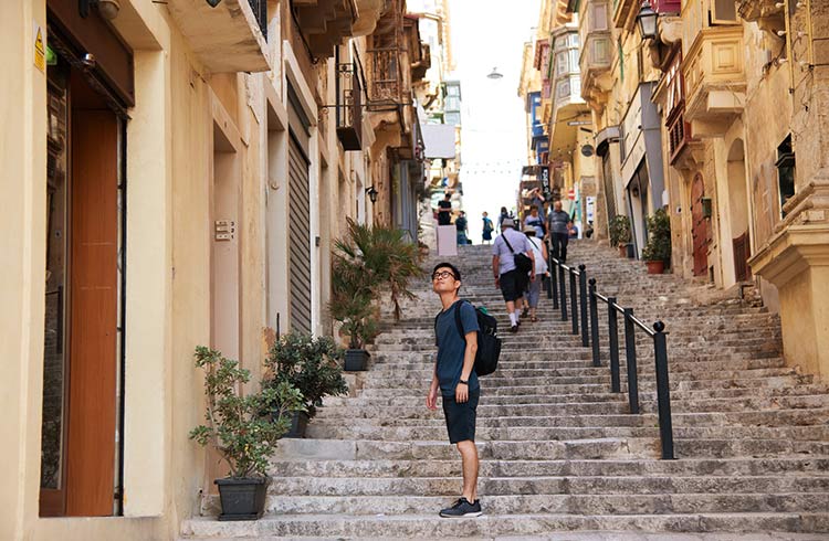 A young man explores the alleyways in Malta