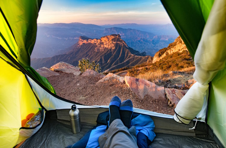 A camper looks out the door of his tent onto the Sierra Gorda rock formations in Mexico.