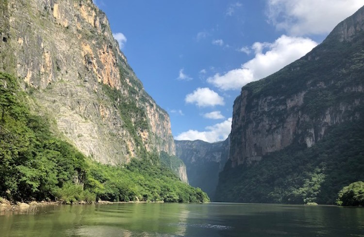 High cliffs rise above the river in Sumidero Canyon, Chiapas, Mexico.