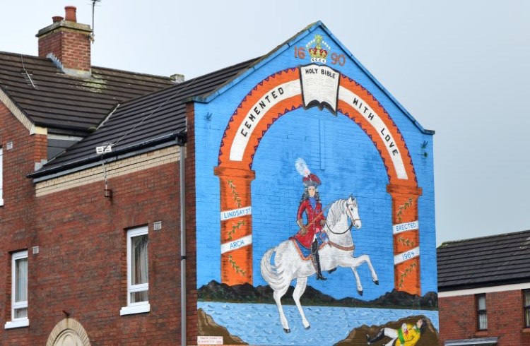 A political mural painted on a the side of a brick building in Belfast.
