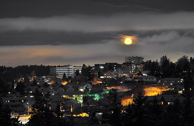 A full moon rising above Oslo, Norway