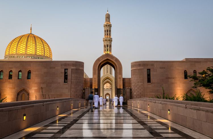 People being called to prayer at the Sultan Qaboos Grand Mosque, Muscat, Oman