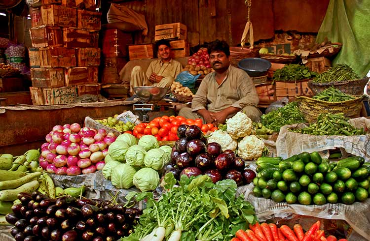 Two male vendors selling the fresh vegetable at Lea Market, Karachi