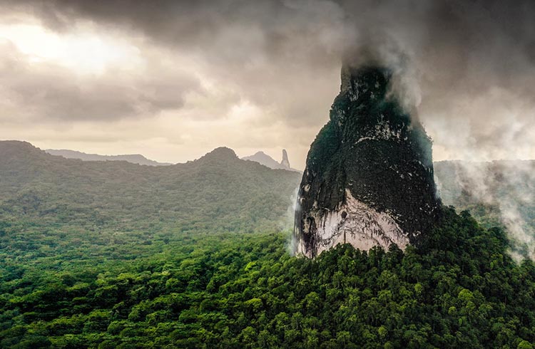 Rock peak formation, cloudy sky and dramatic clouds and dark sky