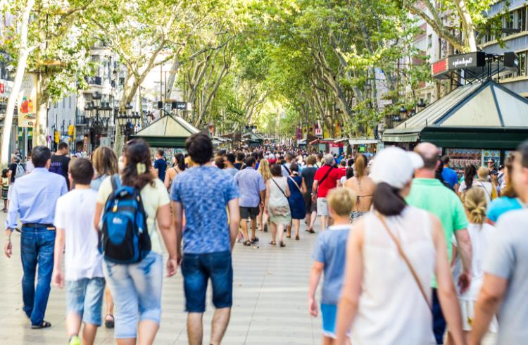 Tourists walk down Las Ramblas, a famous boulevard in Barcelona, Spain.