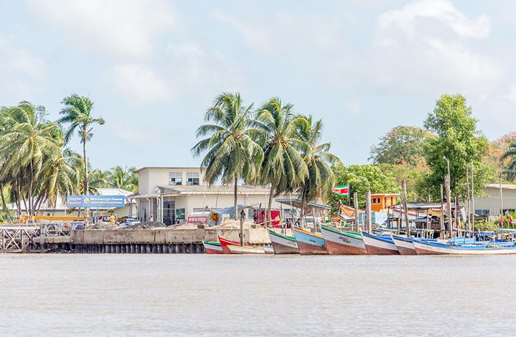 Colorful boats line the river in Suriname