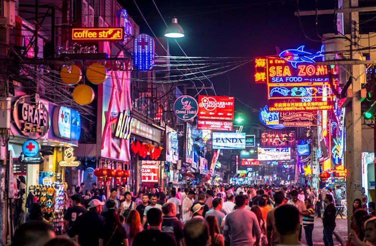 Crowds and neon signs in a busy nighltife area of Pattaya, Thailand.