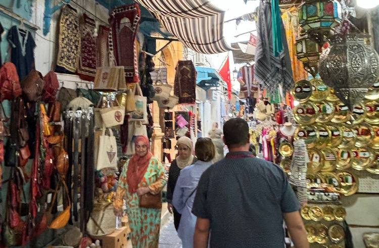 Shoppers walk through the narrow alleys of the souk in Tunis medina.