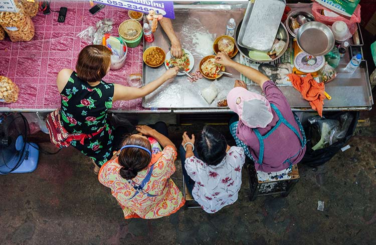 Vendors eating lunch at Warorot market, Chiang Mai