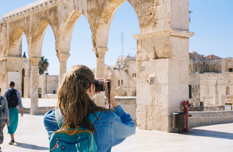 Woman Taking Pictures of Ruins in Israel