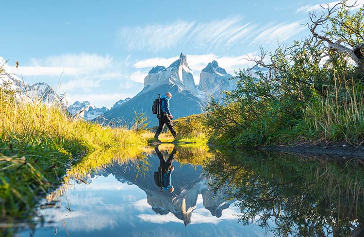 A man crossing a pond in Torres del Paine National Park, Chile