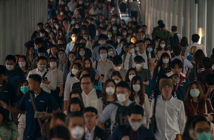 Crowds of people wearing face masks in Bangkok