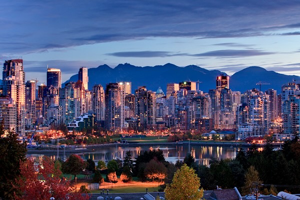 A lit up Vancouver skyline at dusk