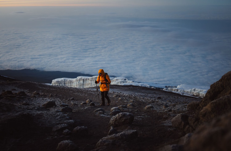 Hiker approaching the Uhuru Peak, the highest point of Mount Kilimanjaro.