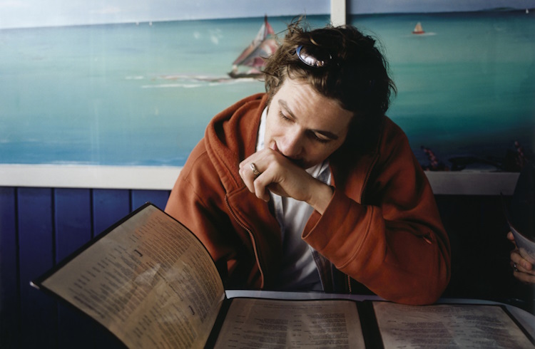 A man studies a menu in a restaurant in Greece.