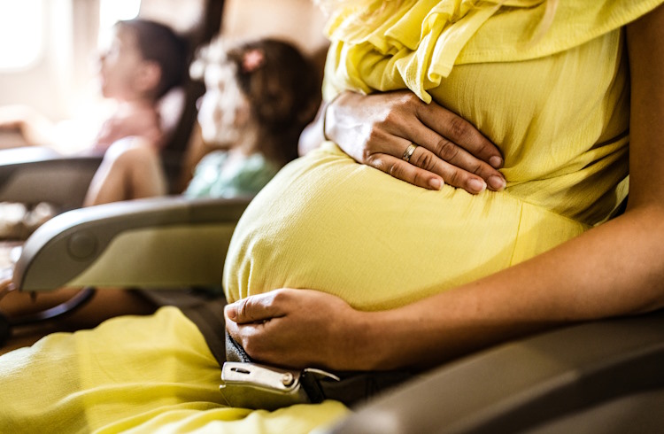 A pregnant passenger on an airplane.