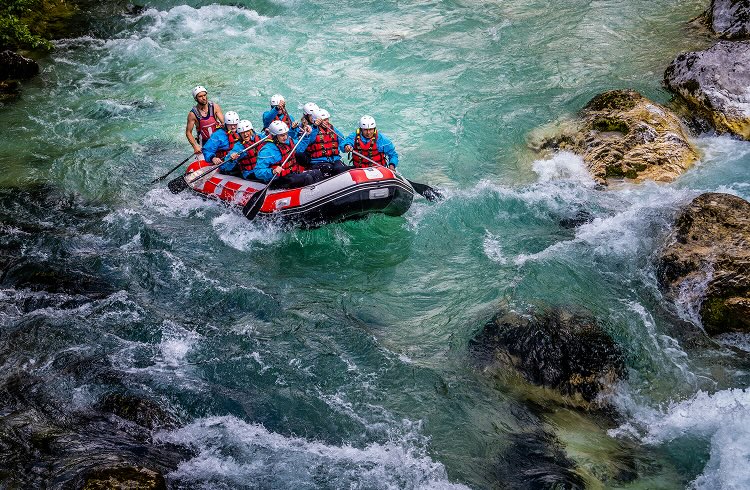 A group of people white water rafting