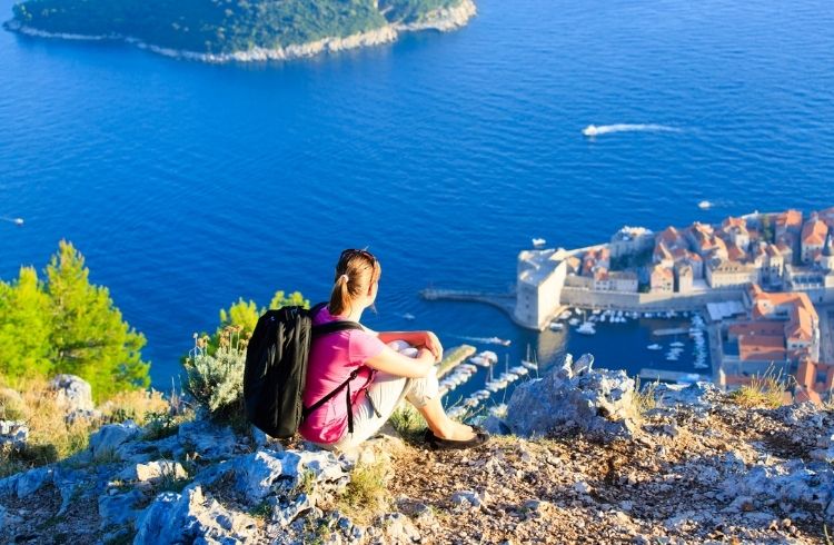 A tourist overlooking a scenic view in Croatia