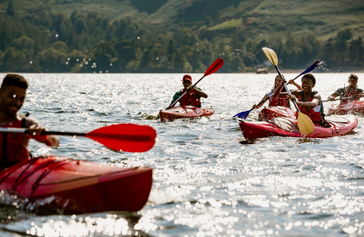 A group of friends having fun kayaking on Derwent Water in The Lake District