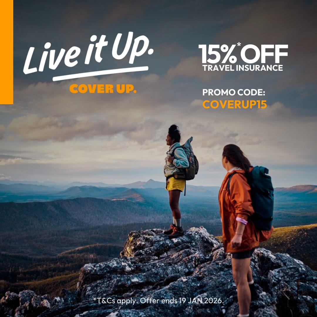 A woman standing on a hill looking over a view