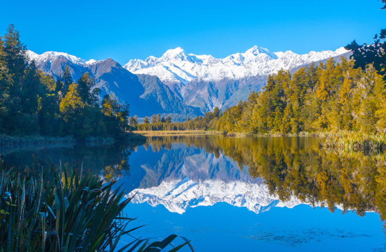 Reflection of mountains in the lake Matheson, New Zealand